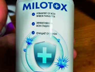 Баночка препарата Milotox в руке крупным планом